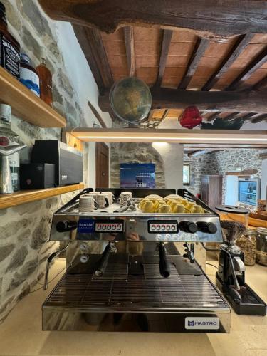 a kitchen with a machine with bread on it at Bio Agriturismo Il Vigno in Caprese Michelangelo