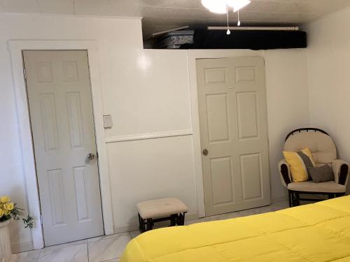 a bedroom with a yellow bed and two chairs at Eitalys on Paris in Hannibal