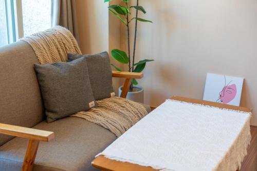 a living room with a couch with a box at Moonlit Corner in Taitung City
