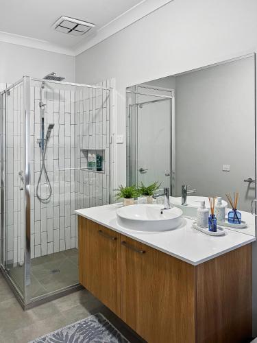 a bathroom with a sink and a shower at Your Perfect Coastal Getaway in Corinella