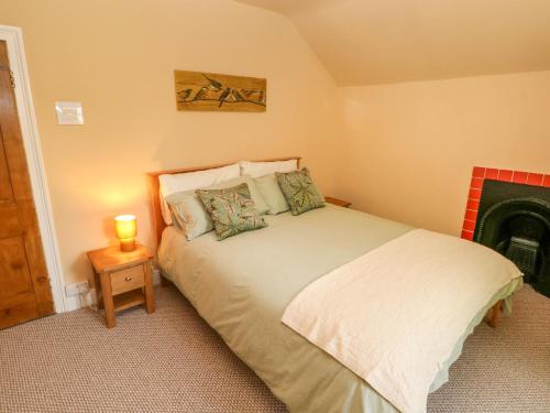 a bedroom with a bed and a fire place at Suffolk House in Narberth