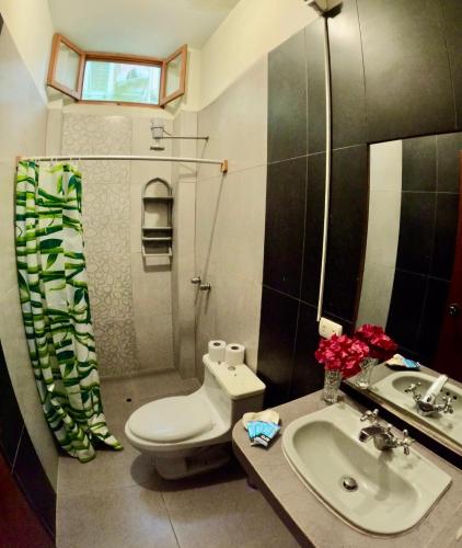 a bathroom with a toilet and a sink at Stone House Mancora in Máncora