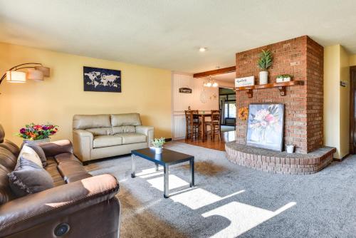 a living room with a couch and a brick fireplace at Cozy Lewiston Home Less Than 10 Mi to Niagara Falls! in Lewiston