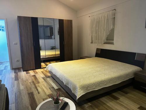 a bedroom with a large bed and a mirror at Deluxe apartment Playa in Valbandon