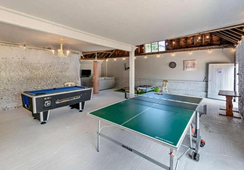 a living room with a ping pong table in it at Luxury Chestnut Lodge with Hot Tub and Games Room in Toppesfield