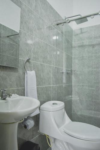 a bathroom with a toilet and a sink at Hotel El Marqués De Manga in Cartagena de Indias