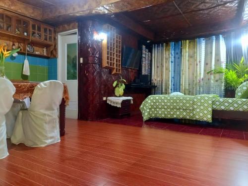 a living room with a couch and a table at Hidden Tourist Inn in Mambajao