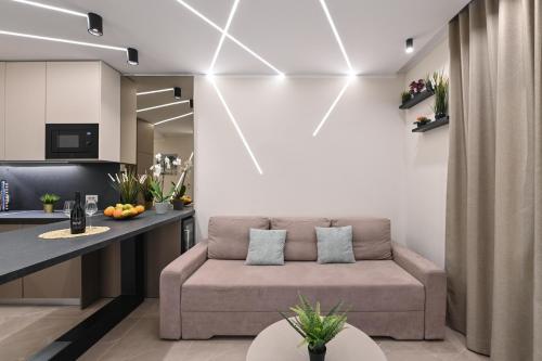 a living room with a couch and a table at Aparthotel OLIVE with jacuzzi and breakfast in Novalja