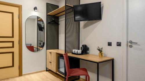 a room with a desk with a chair and a mirror at Rija Old Town Hotel in Tallinn
