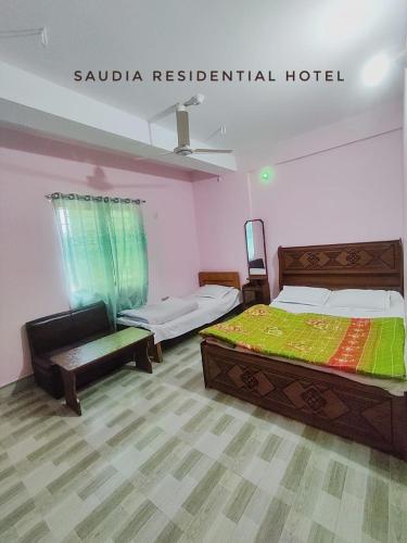 a hotel room with two beds at Saudia residential hotel in Sylhet
