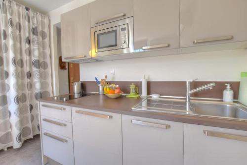 a kitchen with a sink and a microwave at 5 - Cosy Studio in Old Antibes in Antibes