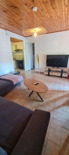 a living room with a couch and a coffee table at Maison du Peyrou in Pradons