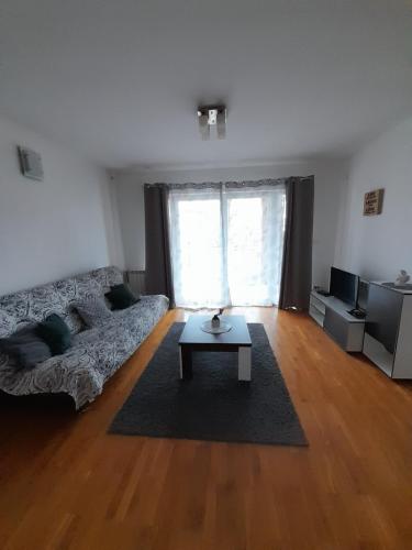 a living room with a couch and a coffee table at Apartment Ken in Surčin
