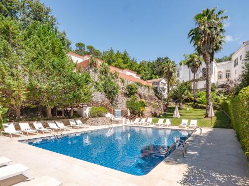 a swimming pool with lounge chairs and a resort at Villa Termal Spa Hotel & Resort in Monchique