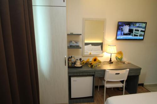 a desk with a lamp and a chair in a room at Century Inn Hotel in Cukai