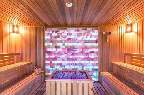 a sauna with a tub in the middle at CENTRAL CHIC APARTAMENT with SPA and GYM in Bucharest