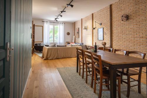 - une salle à manger et un salon avec un mur en briques dans l'établissement Workshop, à Béziers