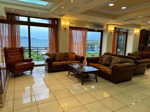 a large living room with couches and a table at Europa Beach Hotel in Galaxidhion