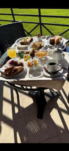 a table with plates of breakfast food on it at Europa Beach Hotel in Galaxidhion