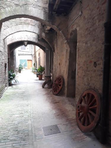 an alley with two wooden wheels in a building at Hotel Minerva in Siena