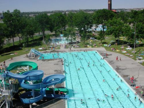 a large swimming pool with people swimming in it at Staybridge Suites Great Falls by IHG in Great Falls