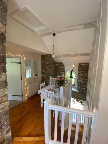 a dining room with a table and chairs at Cosy Llangynidr apartment in Llangynidr