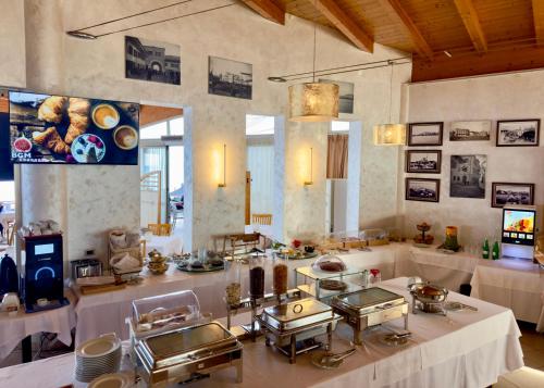 a large room with a table with several dishes at Aragosta Hotel in Durrës