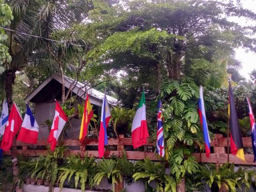a bunch of different colored flags on a fence at Hidden Tourist Inn in Abu