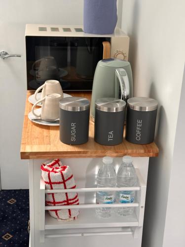 a kitchen counter with a coffee maker and a microwave at Quiet room in Hornchurch near Romford station on Elizabeth line to and from Heathrow airport in Romford