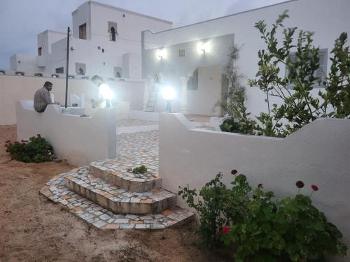 a man sitting at a counter in front of a building at Sassi Villa in Arkou