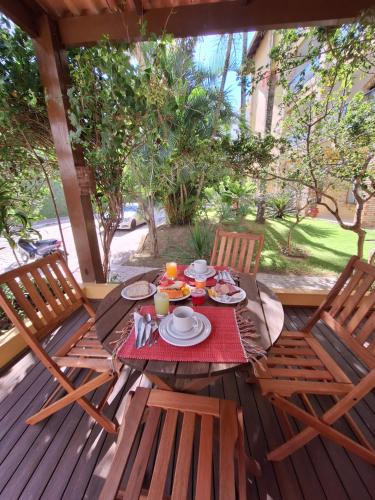 a table with plates of food on a patio at Hotel Joao de Barro in Itajaí