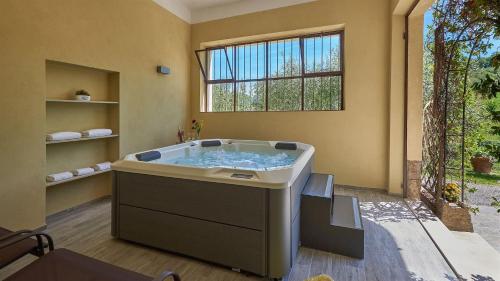 a large bath tub in a room with a window at Il Boschetto in Radda in Chianti