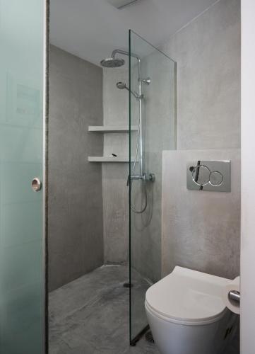 a bathroom with a toilet and a glass shower at Lumina Kardiani in Kardiani