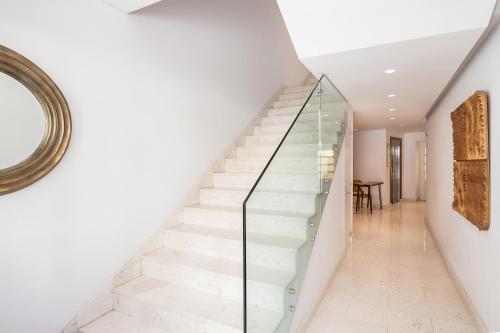 a white staircase with glass railings in a house at Nyx Chic Manor in Chania Town