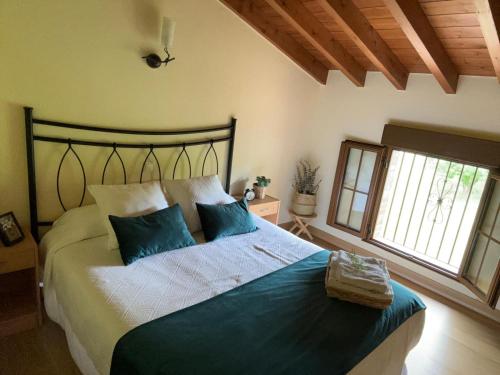 a bedroom with a large bed with blue pillows at La Casa Grande de Cabrales II in Canales