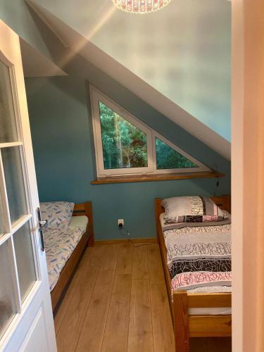 a room with two beds and a window at U Daszków in Zawory