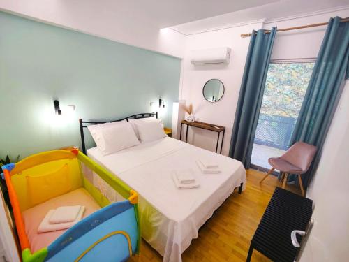 a small bedroom with a bed and a chair at Adagio in Kalamata