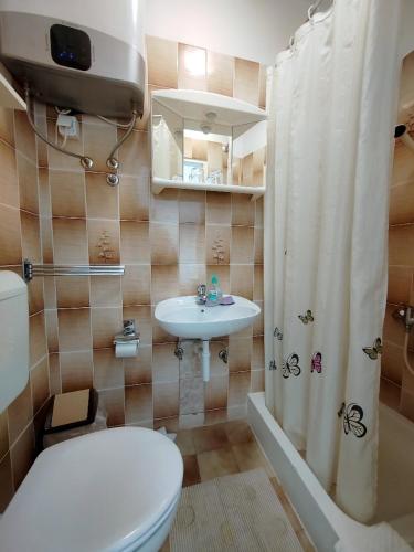 a bathroom with a toilet and a sink and a shower at Bed & Breakfast Josip in Rab