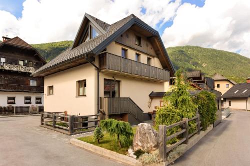 a large white house with a black roof at Chalet Vitranc in Kranjska Gora