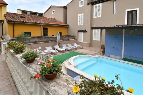 a swimming pool in the backyard of a house at Hotel Innocenti in Montecatini Terme