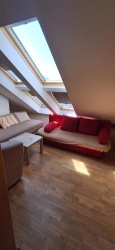 a attic living room with a couch and a skylight at Apartments Seven Castles in Kaštela