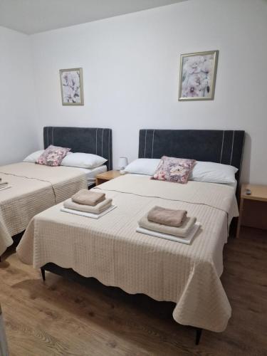 two beds with towels on them in a room at Hotel Riviera, Starigrad Paklenica in Starigrad-Paklenica