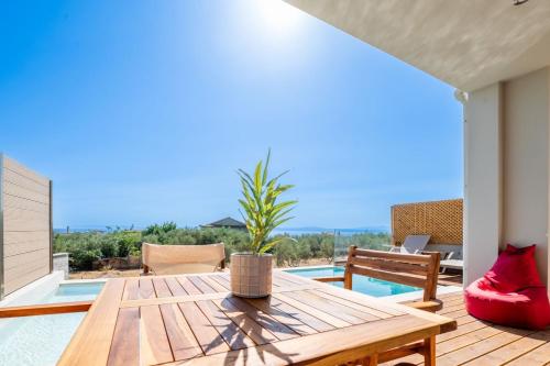 a patio with a table and a view of the ocean at Petradi Suites in Kalamata