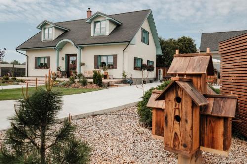a house with a bird house in the yard at OrchardHouse Farmhouse, wellness in Chrast