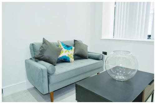 a living room with a couch and a table at The Grandeur Mill in Bradford