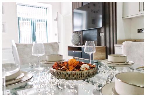 a table with glasses and a bowl of food on it at The Grandeur Mill in Bradford