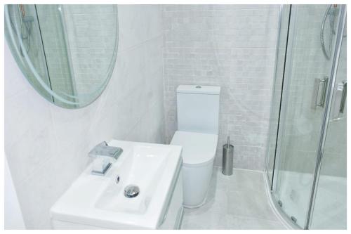 a bathroom with a toilet and a sink and a shower at The Grandeur Mill in Bradford