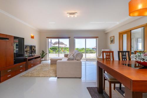 a living room with a couch and a table at Close to the sea, to Lisbon and to your heart in Silveira