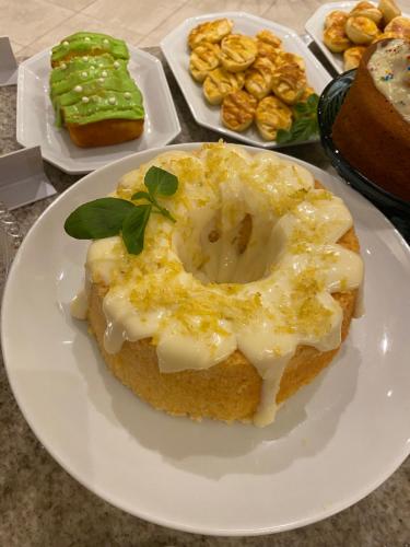 a white plate with a donut with a leaf on it at Altadomo Hotel in Santa Maria
