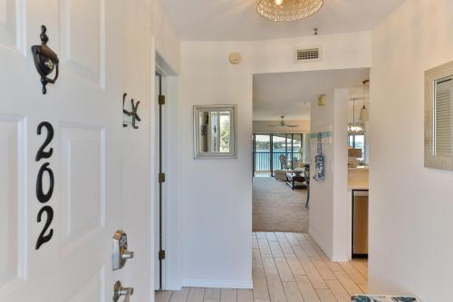 a hallway with a door leading to a living room at 2-2 Riverfront Condo At Bouchelle Island in New Smyrna Beach